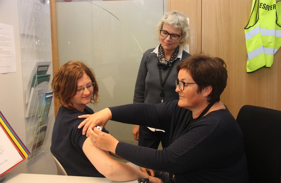 Lene Skartland ved vaksinekontoret gir Nina Haslomo påfyll av vaksine. Lege Iris Klage Håheim i bakgrunnen.
Foto: Irene Mæland Haraldsen